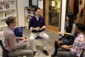 Alan Brown teaches mindfulness to three high school students.