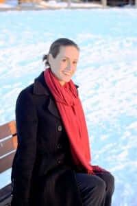 Nicole Libin sits on a snowy bench outside her university classroom. 